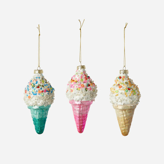 Three ice cream cone ornaments with colorful sprinkles on a white background