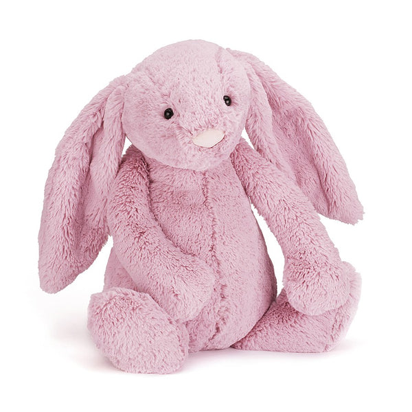 A tulip pink plush bunny sitting on a white background