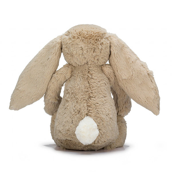 The back of a beige plush bunny with a white fluffy tail.