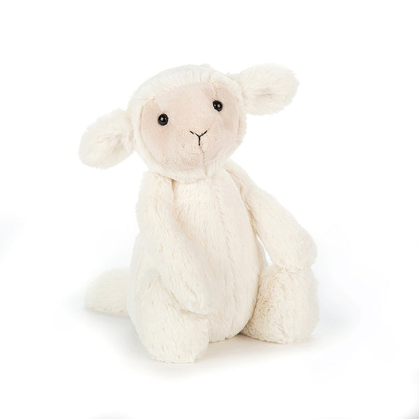 A small white fluffy plush lamb with a cream colored sweet face.