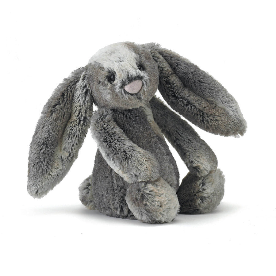 A grey plush woodland bunny sitting on a white background.